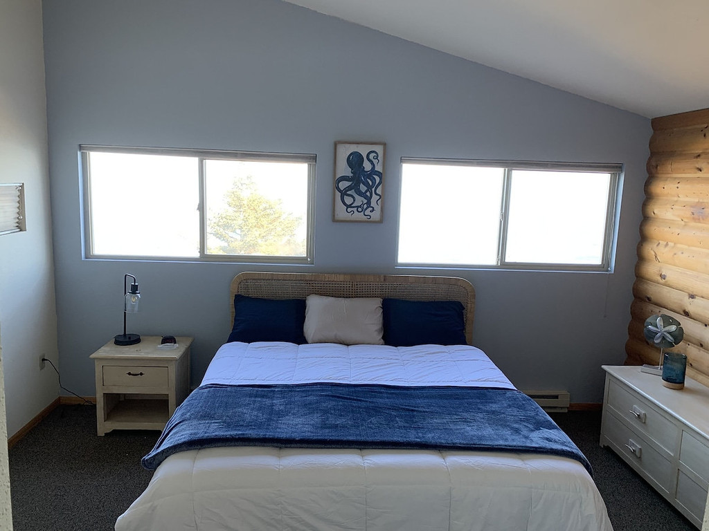 Halibut Suite king bed with big windows facing the ocean